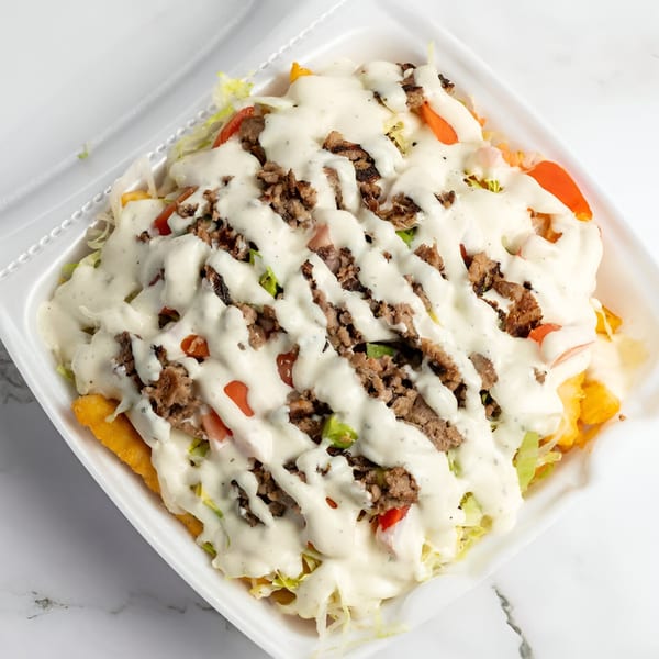 Cali Style Burger's loaded fries with ground beef, lettuce, tomatoes, and white sauce in a styrofoam container.