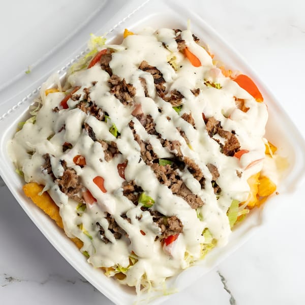 Cali Style Burger's loaded fries topped with ground beef, lettuce, tomatoes, and white sauce.