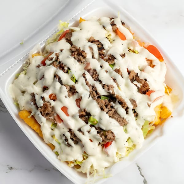 Cali Style Burger's loaded fries with ground beef, lettuce, tomatoes, and white sauce in a takeout container.